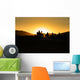 Silhouettes of tourists riding camels on dunes Wall Mural