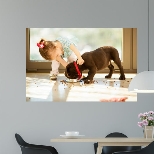Cute little girl feeding her puppy 