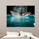 Muscular young man in blue cap in swimming pool 