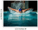 Muscular young man in blue cap in swimming pool 