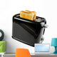Black toaster with bread slices , isolated on white 
