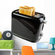 Black toaster with bread slices , isolated on white 