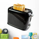 Black toaster with bread slices , isolated on white 