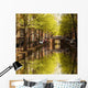 Amsterdam city with green canal in Holland Wall Mural