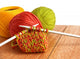 Wool and knitting needles closeup on wooden background. 