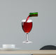 pouring red wine from the bottle into a glass 