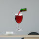 pouring red wine from the bottle into a glass 