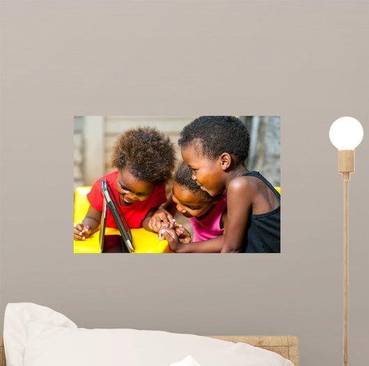 Threesome african kids having fun with tablet. 