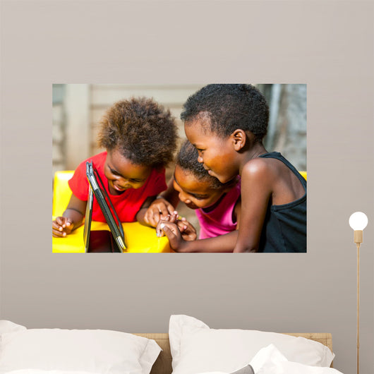 Threesome african kids having fun with tablet. 