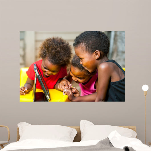 Threesome african kids having fun with tablet. 