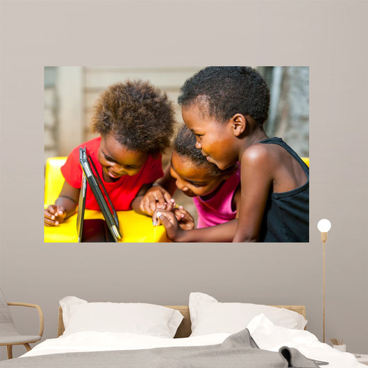 Threesome african kids having fun with tablet. 