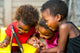 Threesome african kids having fun with tablet. 