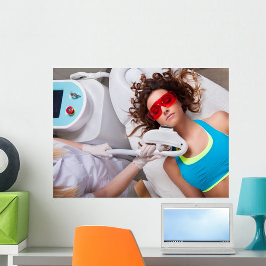 Woman getting laser face treatment in medical spa center 