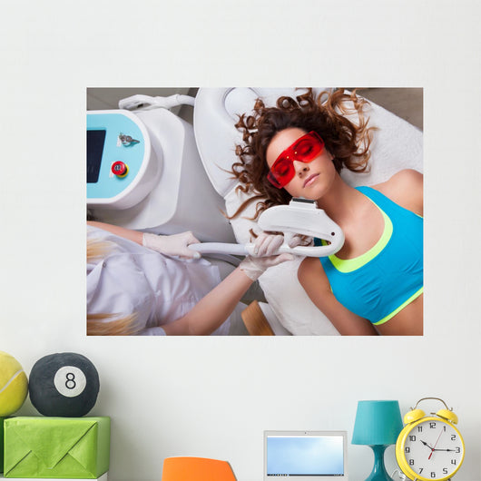 Woman getting laser face treatment in medical spa center 