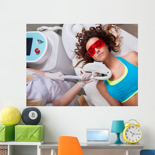 Woman getting laser face treatment in medical spa center 