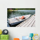 Old Row Boat  with Lifejackets Moored to Dock in Lake 