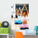 people at the gym taking a class smiling Wall Mural