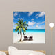 Relaxing under a palm tree on remote beach. 