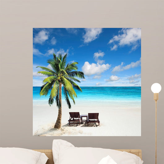 Relaxing under a palm tree on remote beach. 