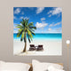Relaxing under a palm tree on remote beach. 
