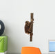 Side View of a Young Bornean Orangutan Climbing on a Tree Trunk Wall Decal