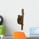 Side View of a Young Bornean Orangutan Climbing on a Tree Trunk Wall Decal