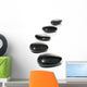 Five black pebbles in a gentle curve on a white surface Wall Mural