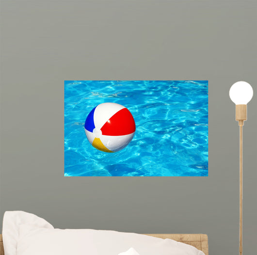 Beach ball in swimming pool Wall Mural