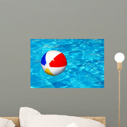 Beach ball in swimming pool Wall Mural