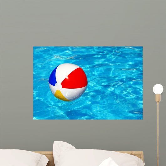 Beach ball in swimming pool Wall Mural