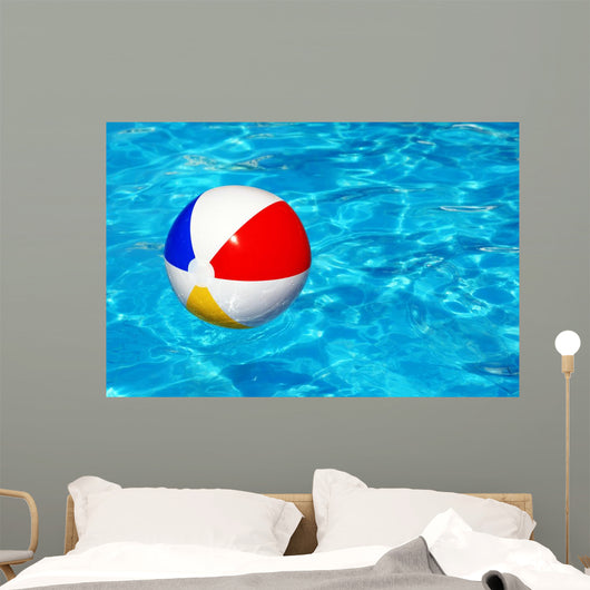 Beach ball in swimming pool Wall Mural