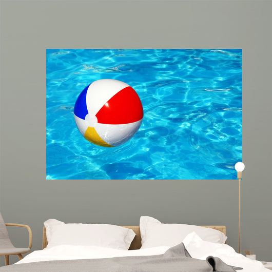 Beach ball in swimming pool Wall Mural