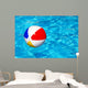 Beach ball in swimming pool Wall Mural