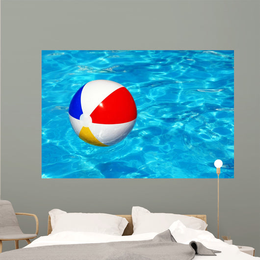 Beach ball in swimming pool Wall Mural