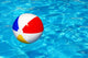 Beach ball in swimming pool Wall Mural