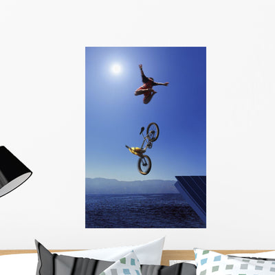 Cyclist Going off Jump Wall Mural shown on a wall