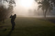 Early Morning Golfers in a Dense Fog 