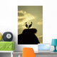 white storks on nest on rock at sunset Wall Mural