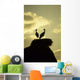 white storks on nest on rock at sunset Wall Mural
