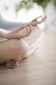 Woman meditating in the lotus position closeup 
