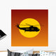 Helicopter Flying Passing Sun at Sunset Wall Mural