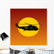 Helicopter Flying Passing Sun at Sunset Wall Mural
