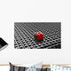 Black lego background with one red block standing out 
