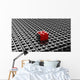 Black lego background with one red block standing out 