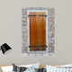 Large wooden shutters in a stone wall 