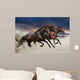 Horses running at a gallop along the sandy field Wall Mural