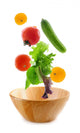 Assorted fresh vegetables falling into a wooden salad bowl Wall Decal