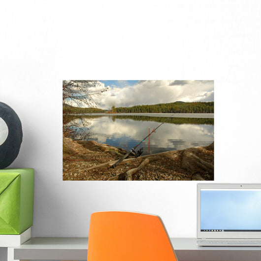 Fishing Rod Placed on the Ground near a  Lake Outdoors at a Recr Wall Mural