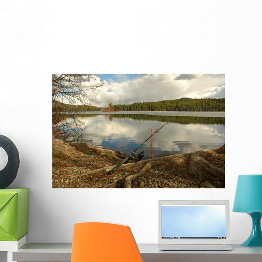 Fishing Rod Placed on the Ground near a  Lake Outdoors at a Recr Wall Mural