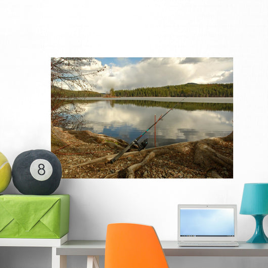 Fishing Rod Placed on the Ground near a  Lake Outdoors at a Recr Wall Mural